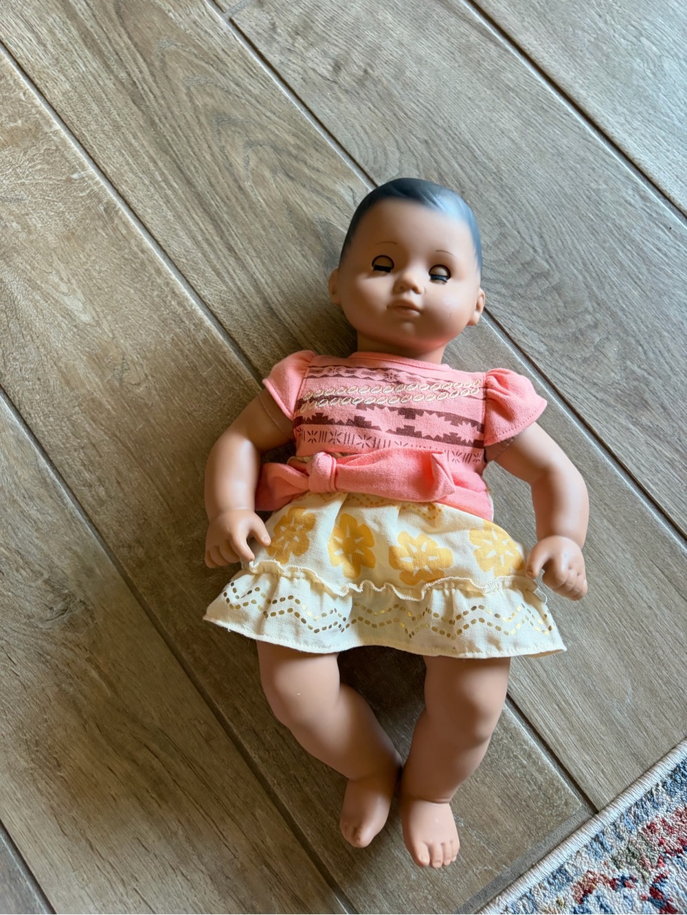 American Girl Bitty Baby doll is dressed in a Disney Moana-inspired outfit